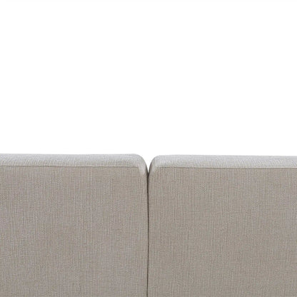 Close-up of a light gray sofa corner on a white background