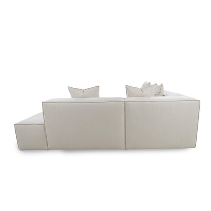 Light gray sectional sofa with two cushions on a white background