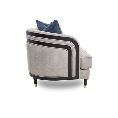 Gray armchair with black accents and a blue cushion on a white background