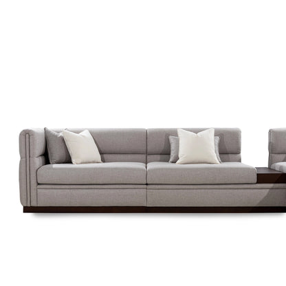 Gray sectional sofa with cushions on a white background