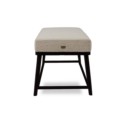 Stool with beige cushioned seat and black legs on a white background