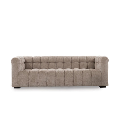 Beige tufted sofa on a white background