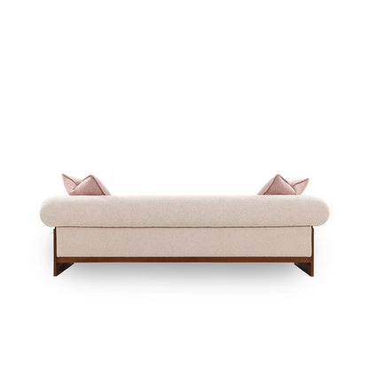 Beige sofa with wooden legs and pink cushions on a white background