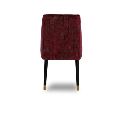 Red velvet chair with black legs on a white background