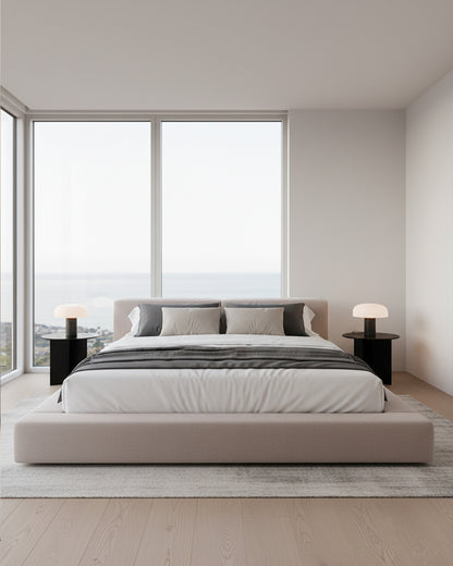 Modern bedroom with a large bed and large windows.