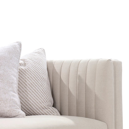 Beige sofa with decorative pillows on a white background