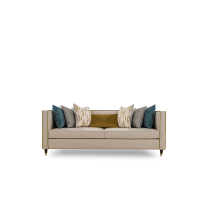 Beige sofa with colorful cushions on a white background