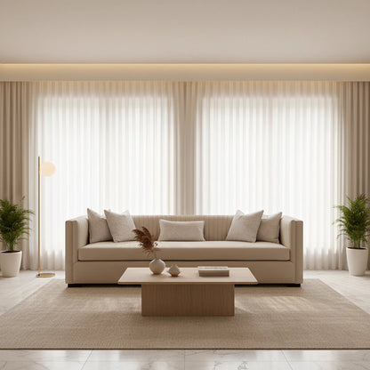 Modern living room with a beige sofa, coffee table, and decorative elements.
