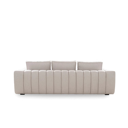 Beige sofa with three cushions on a white background