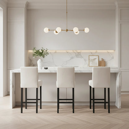 Modern kitchen with marble countertop, white chairs, and decorative elements.