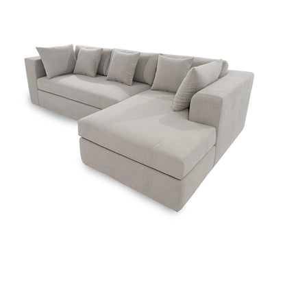 Gray sectional sofa with cushions on a white background