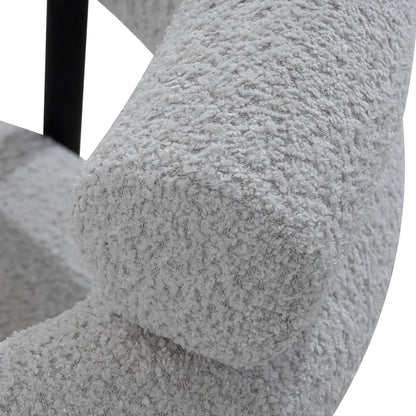 Close-up of a textured gray chair armrest with a white background