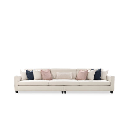 Beige sofa with colorful cushions on a white background