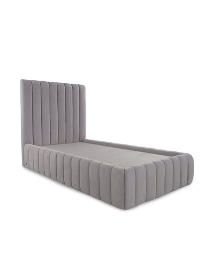 Gray upholstered bed with tufted design on a white background