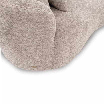 Close-up of a beige textured chair with a visible brand logo on a white background