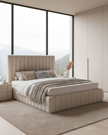 Beige upholstered bed in a modern bedroom with large windows.