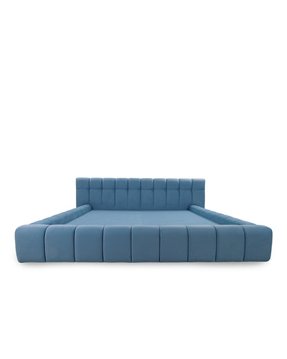 Blue upholstered bed on a white background