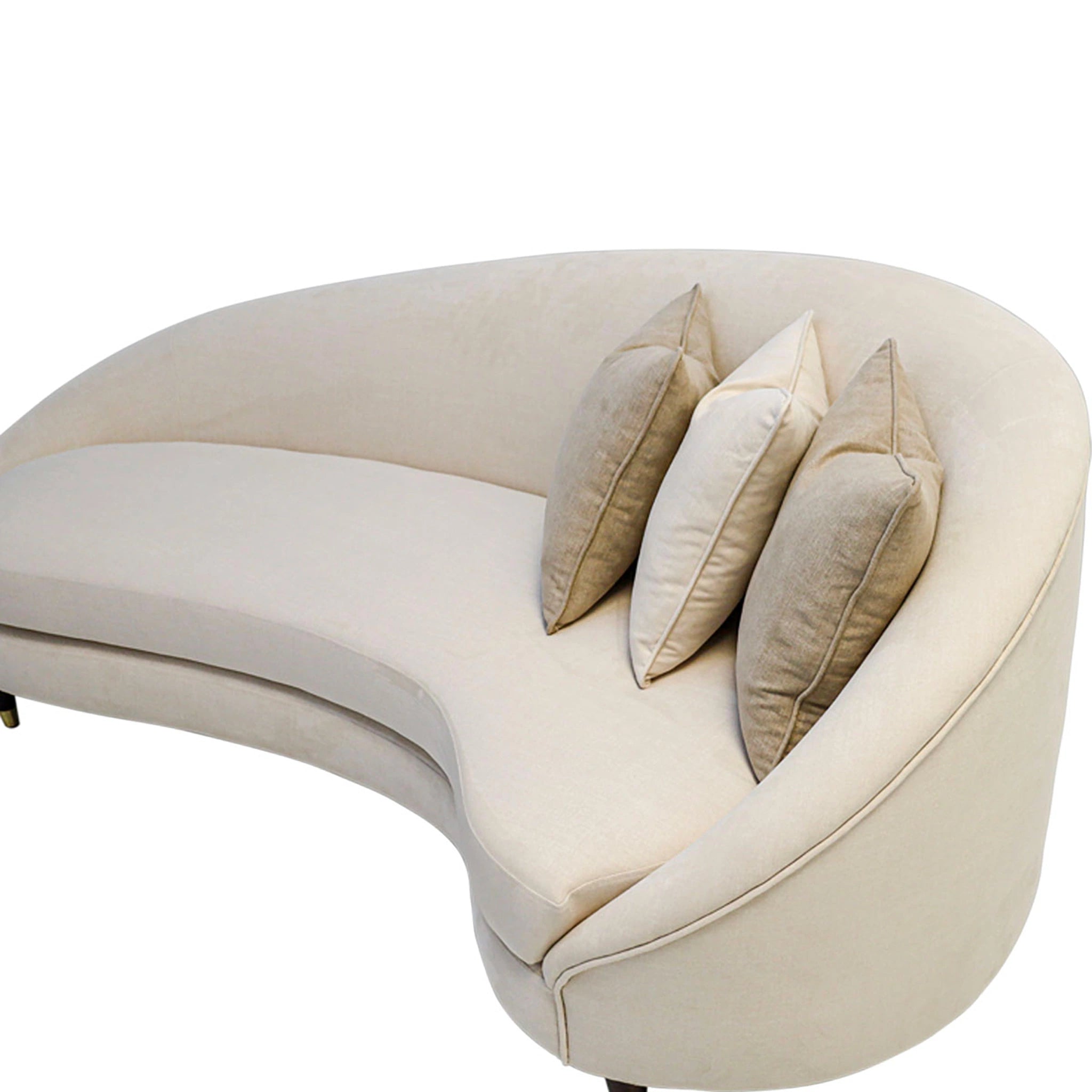 Beige curved sofa with three pillows on a white background