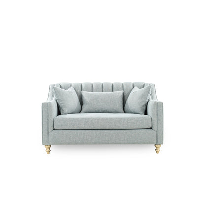 Light gray sofa with three cushions on a white background