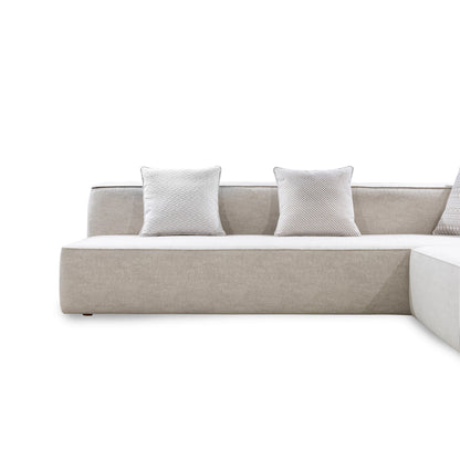 Beige sofa with two white pillows on a white background