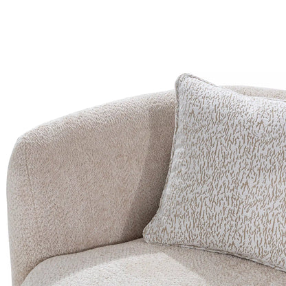 Close-up of a textured beige sofa with a matching pillow on a white background