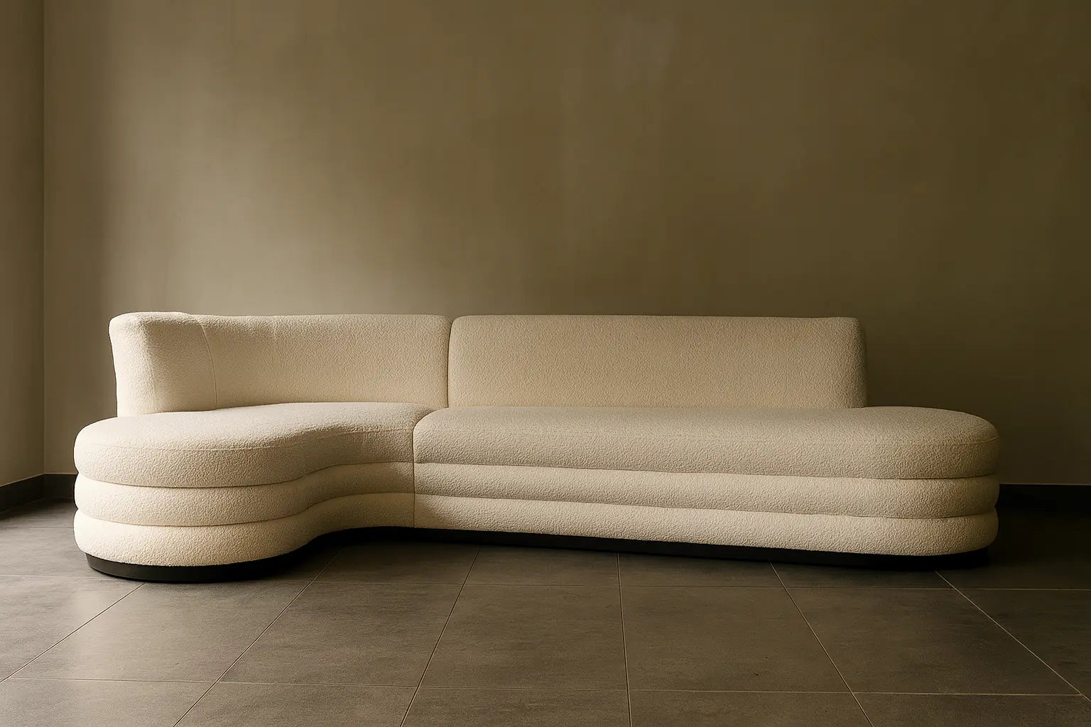 Beige sectional sofa against a plain wall
