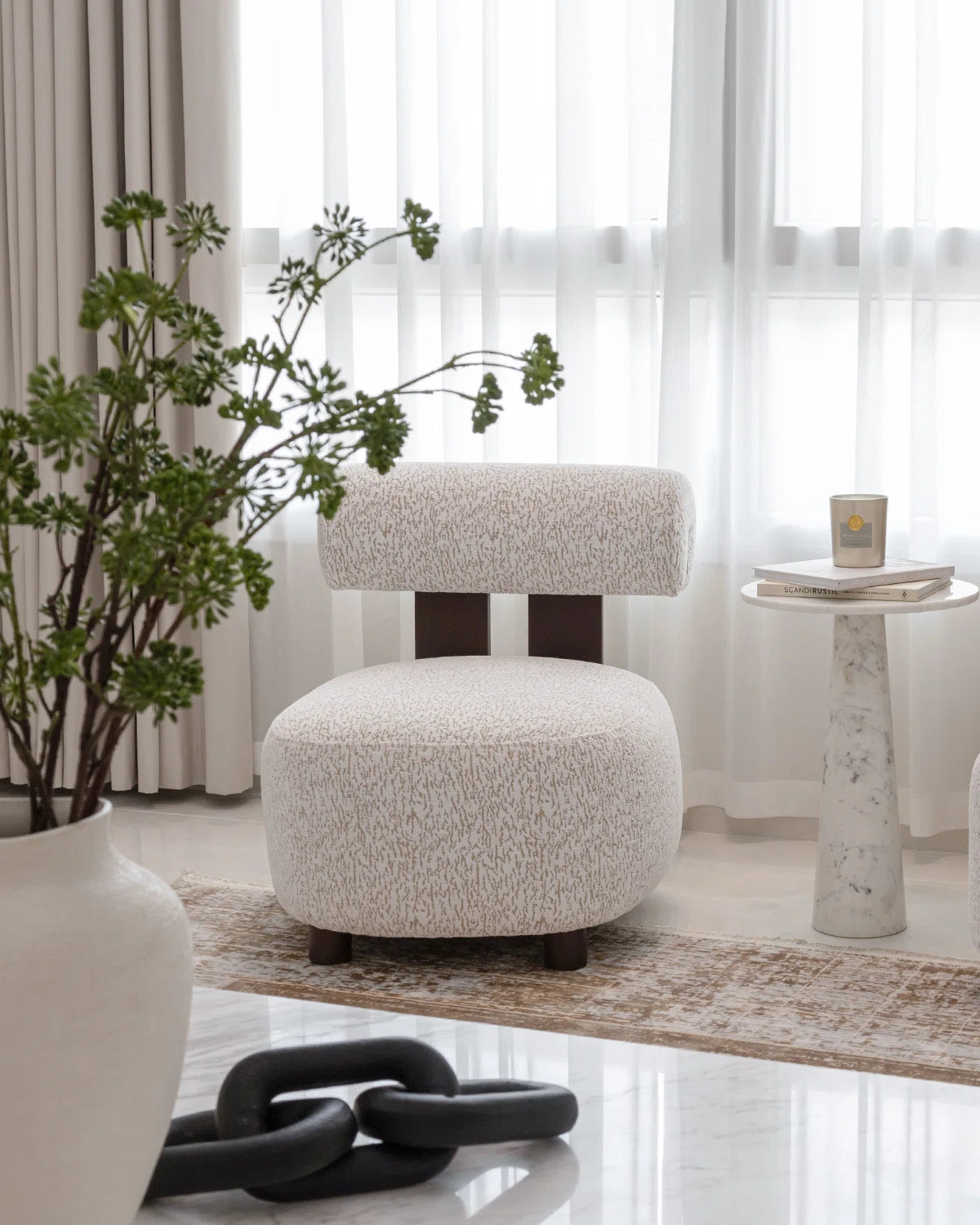Decorative chair in a room with a plant and small table