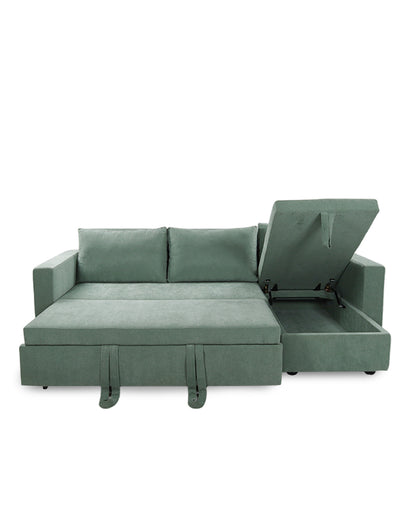 Green sectional sofa with a bed extension on a white background
