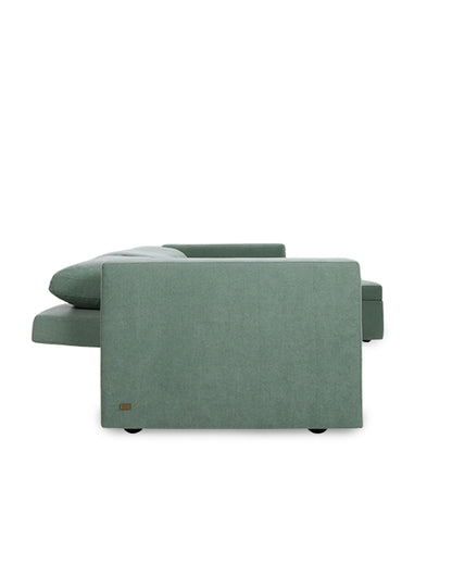 Green sectional sofa on a white background